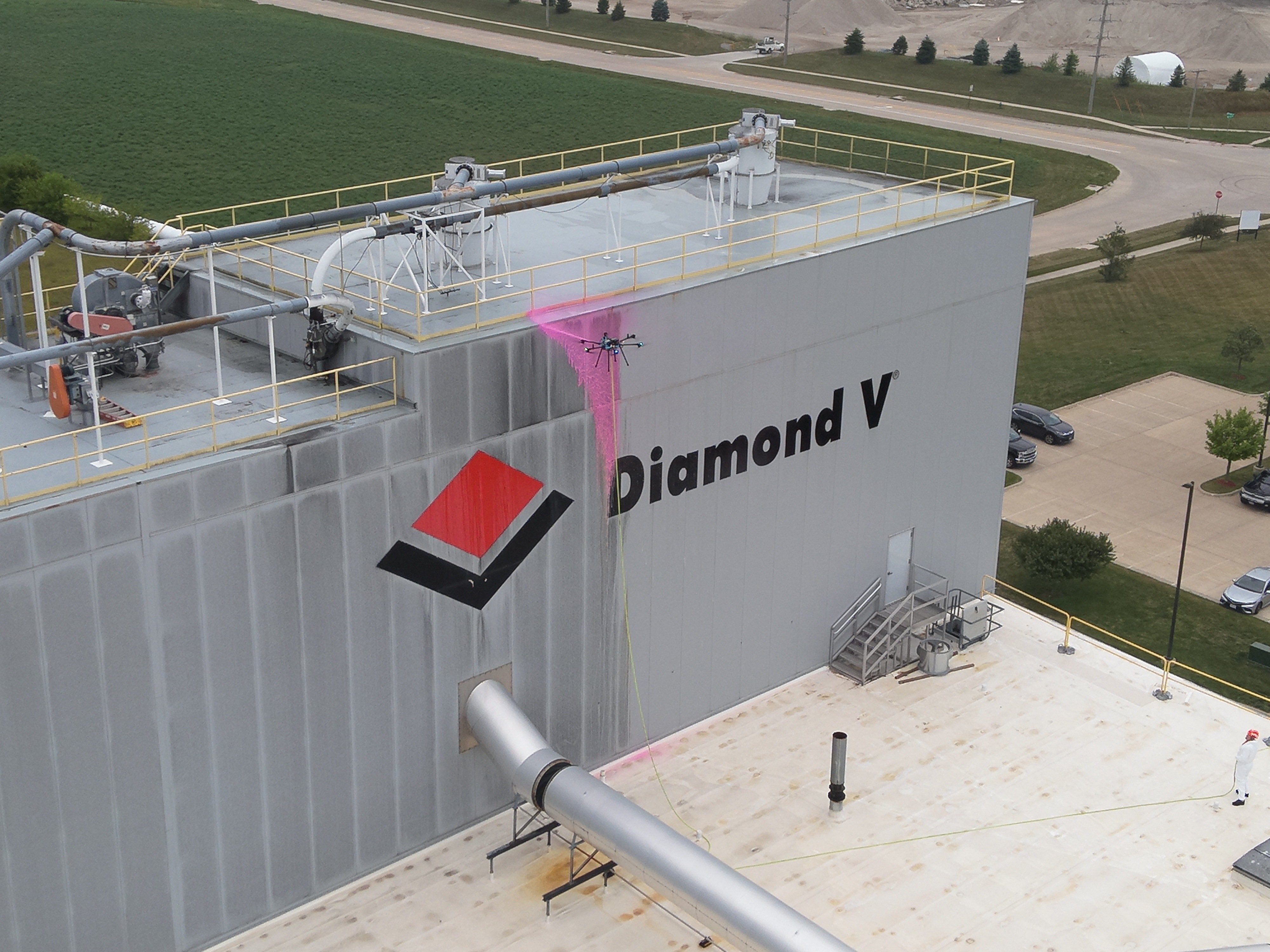 Sherpa drone cleaning a high-rise structure and solar panels
